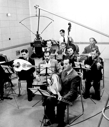 An ensemble of Arab and Jewish musicians in a studio of the Palestinian Broadcasting Service (PBS) Jerusalem 1940 Photo: Moshe & Trudy Schwarz The Younes and Soraya Nazarian Library, University of Haifa © Bitmuna